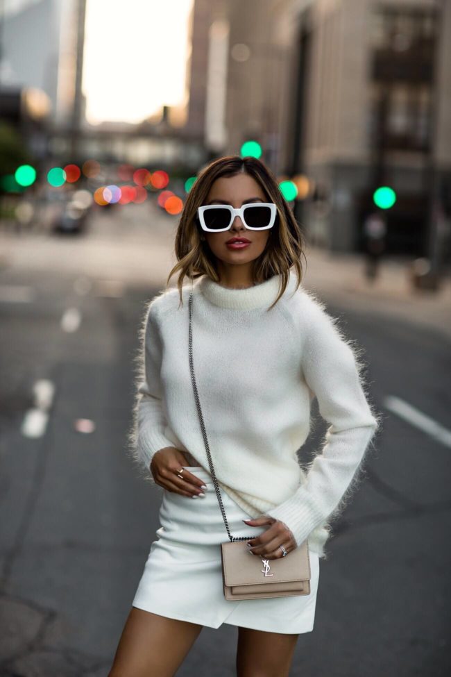 fashion blogger mia mia mine wearing a white mohair sweater and a white leather intermix skirt with white celine sunglasses