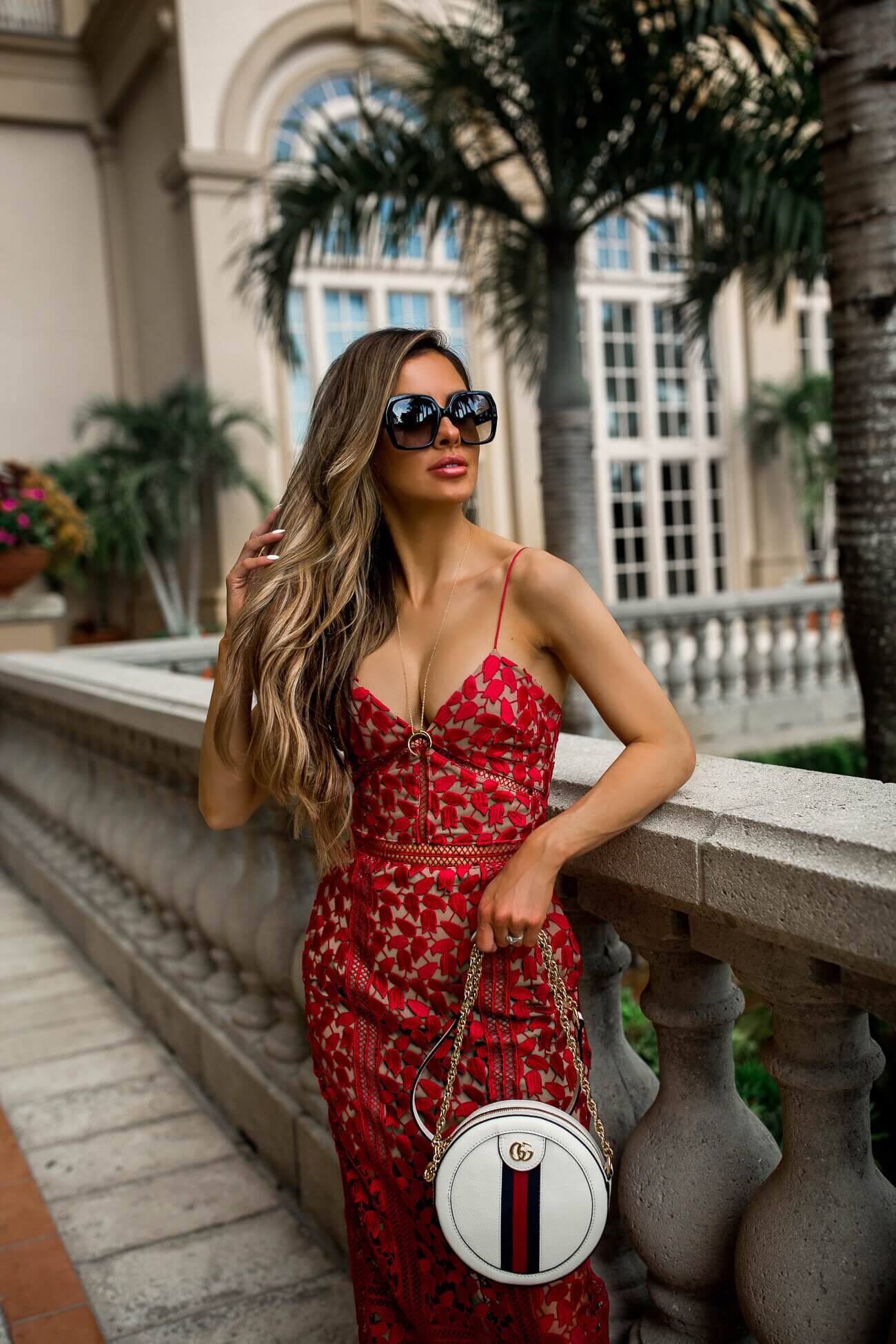Fashion blogger mia mia mine wearing a a red lace dress by self-portrait and gucci sunglasses