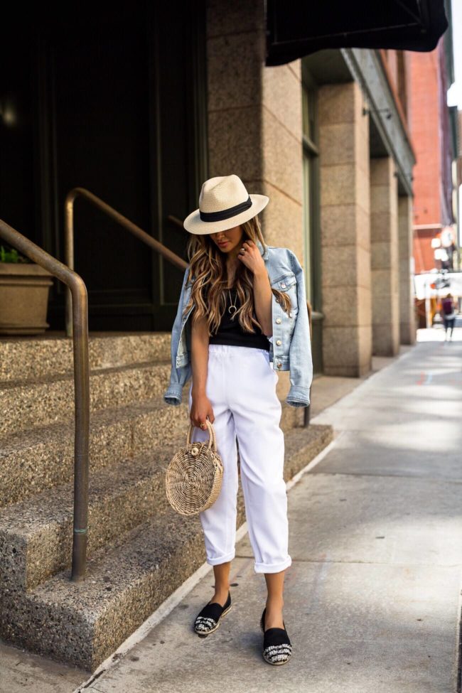 fashion blogger mia mia mine wearing a panama hat and white linen pants from walmart