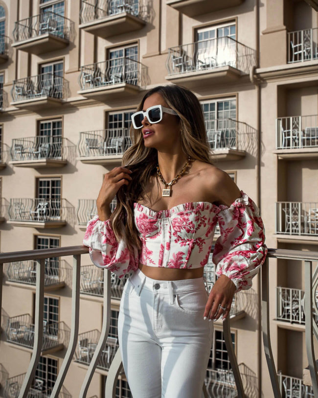 fashion blogger mia mia mine wearing a pink top from revolve in naples florida at the ritz-carlton