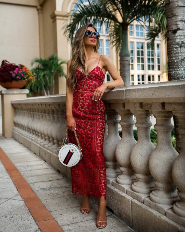 fashion blogger mia mia mine wearing a red lace self-portrait dress and a gucci mini ophidia bag