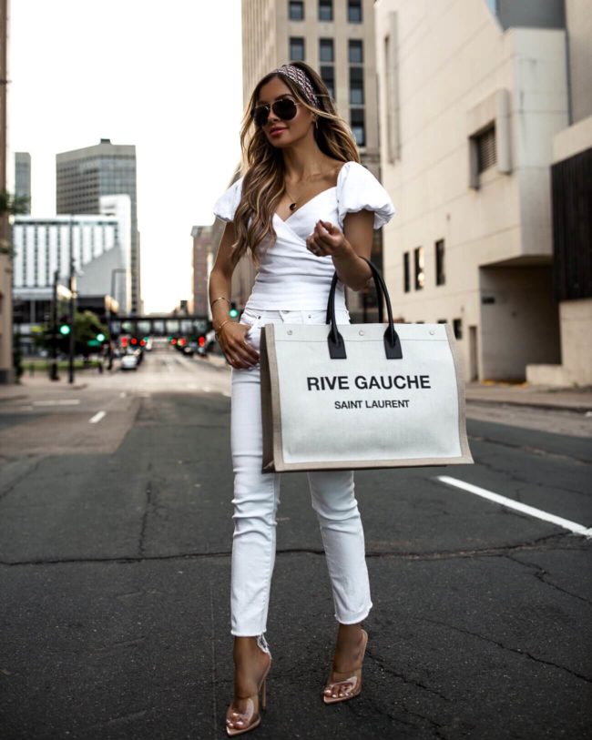 fashion blogger mia mia mine wearing a white outfit with a dior headscarf and saint laurent rive gauche tote