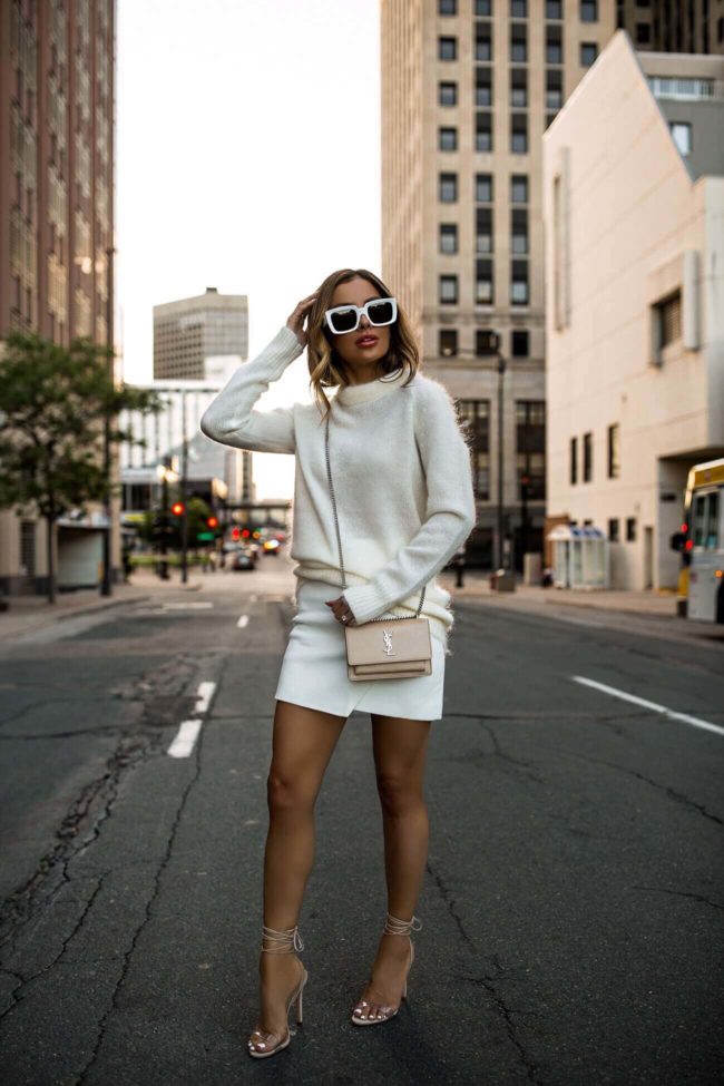 fashion blogger mia mia mine wearing a white rag & bone sweater and a white leather intermix skirt with revolve x schutz heels