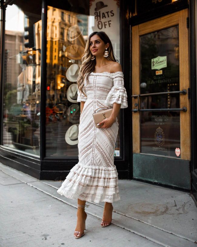 fashion blogger mia mia mine wearing a white lace off the shoulder dress 
