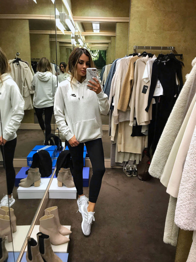 fashion blogger mia mia mine wearing a nike sweatshirt and adidas sneakers from the nordstrom anniversary sale 2019