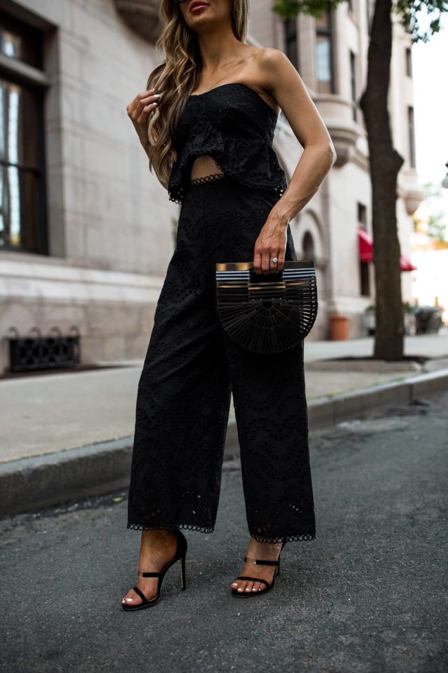 fashion blogger mia mia mine wearing an eyelet jumpsuit and a cult gaia bag
