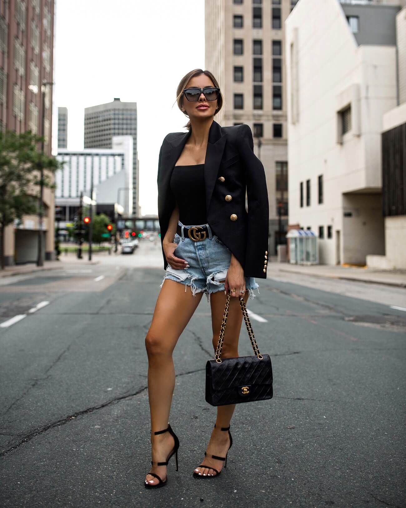 fashion blogger mia mia mine wearing a balmain blazer and distressed levi's denim shorts