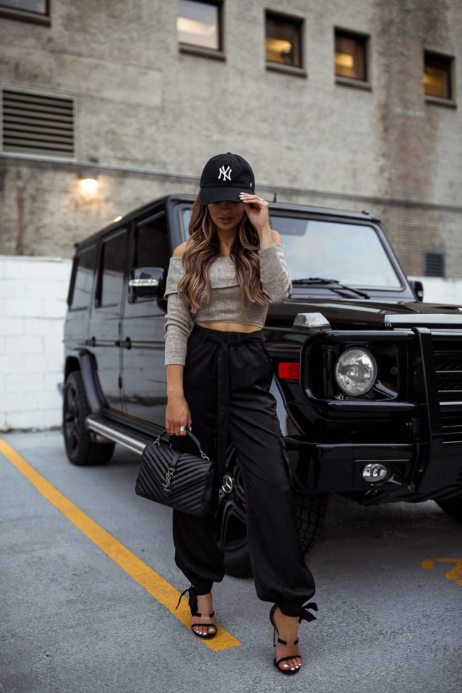 fashion blogger mia mia mine wearing a crop top from revolve and black jogger pants