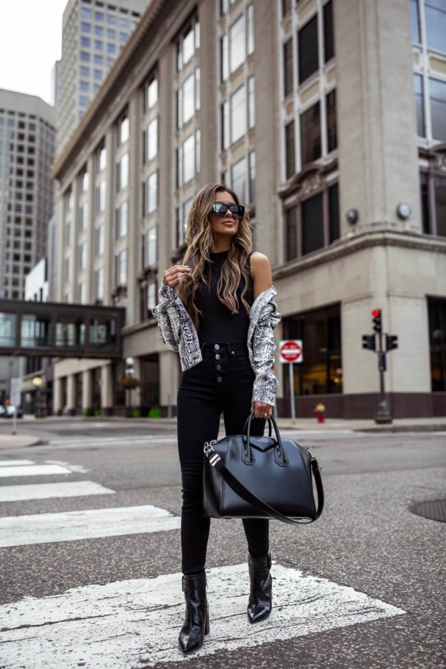 fashion blogger mia mia mine wearing a snakeskin jacket and a black givenchy antigona bag