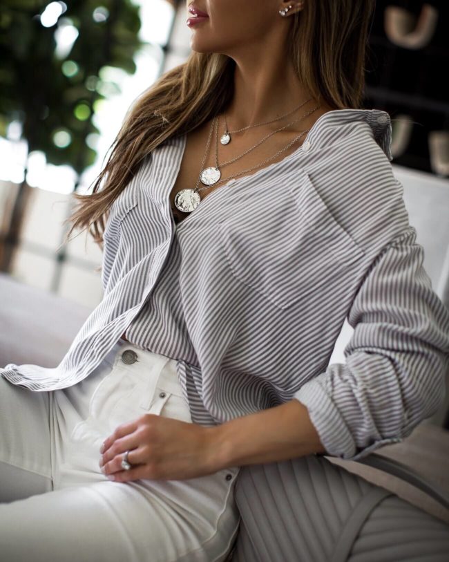 fashion blogger mia mia mine wearing white levi's and a striped top from abercrombie in home office