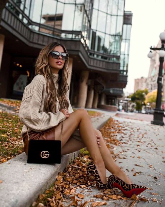 fashion blogger mia mia mine wearing an lpa sweater and a majorelle brown leather skirt from revolve