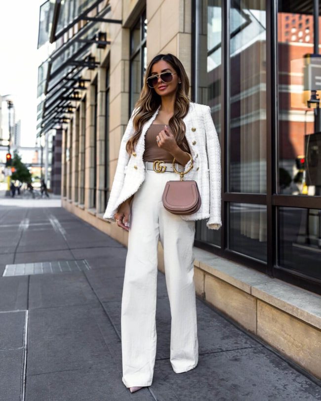 fashion blogger mia mia mine wearing a white work outfit and gucci belt at hotel ivy minneapolis