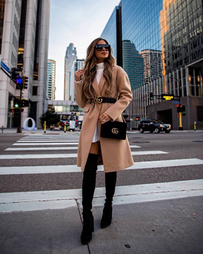 fashion blogger mia mia mine wearing a camel coat and gucci velvet marmont bag with black over-the-knee boots