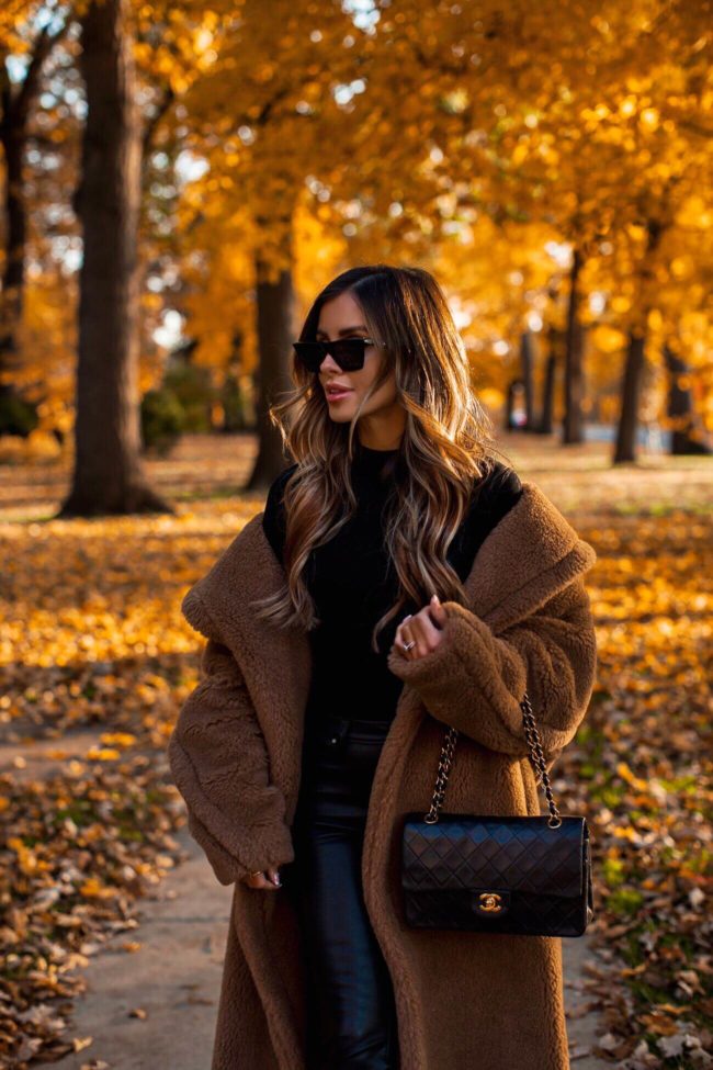 fashion blogger mia mia mine wearing a max mara teddy bear coat and a chanel bag