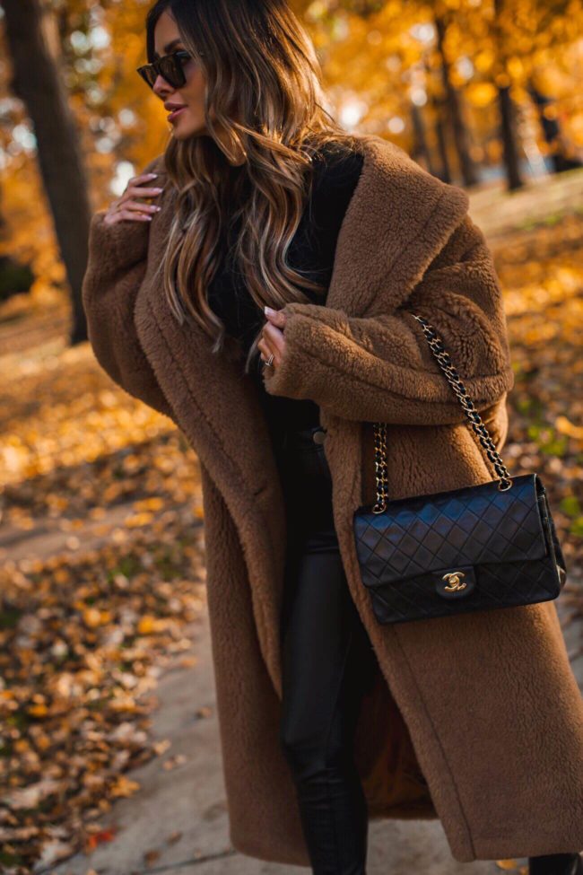 fashion blogger mia mia mine wearing a chanel bag and a teddy bear coat