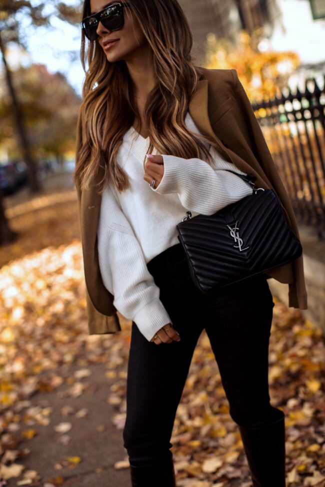 fashion blogger mia mia mine wearing a camel blazer and a white chunky sweater