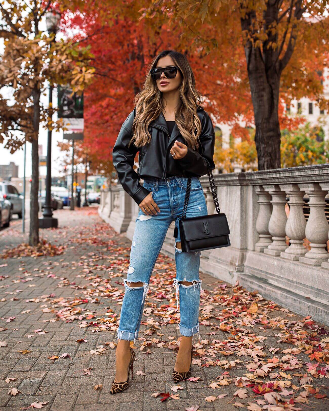 fashion blogger mia mia mine wearing a leather jacket from revolve and grlfrnd ripped jeans