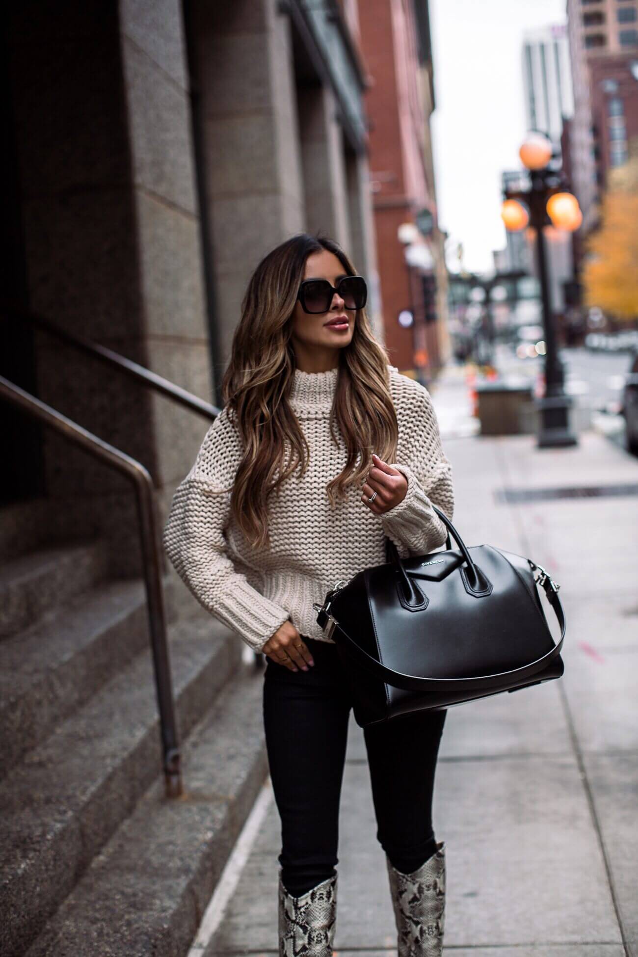 fashion blogger mia mia mine wearing a chunky knit sweater from free people