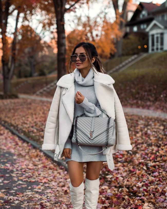 fashion blogger mia mia mine wearing a gray sweater dress and a white zara jacket
