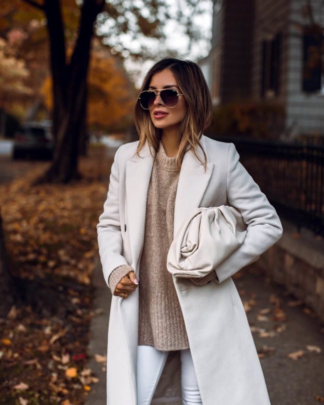 fashion blogger mia mia mine wearing a white coat and a mist bottega veneta the pouch bag for fall