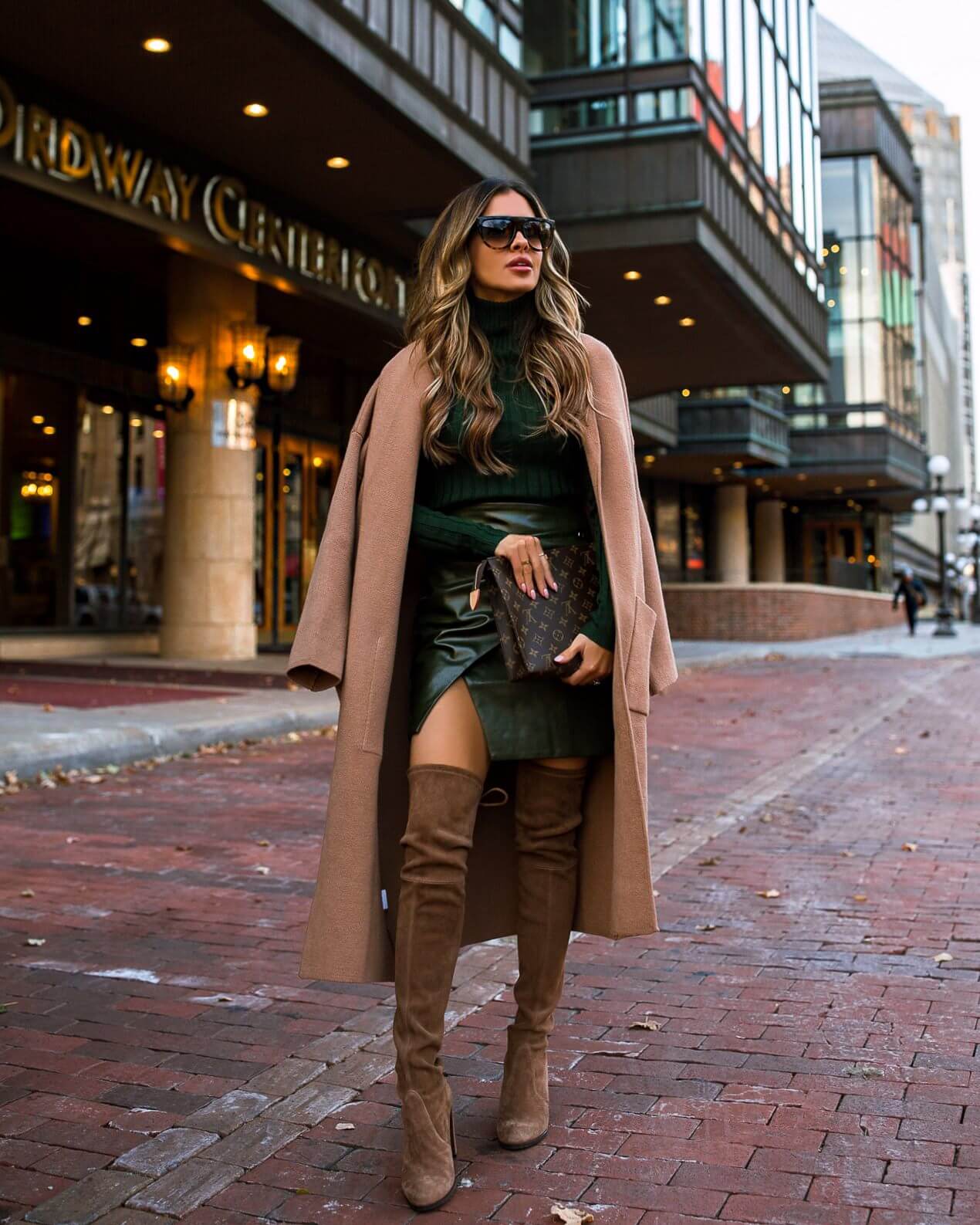fashion blogger mia mia mine wearing a green outfit from revolve with a camel coat for fall 2019