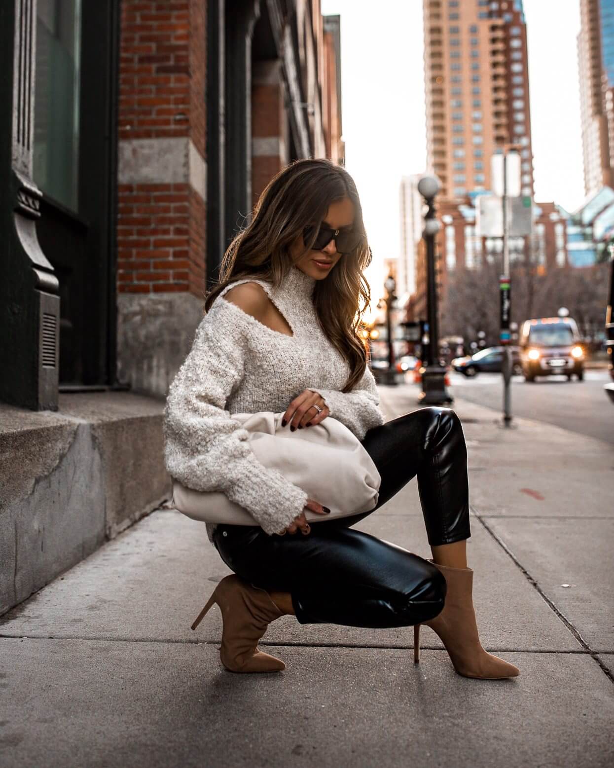 fashion blogger mia mia mine wearing a chunky sweater from express with faux leather pants on sale for black friday 