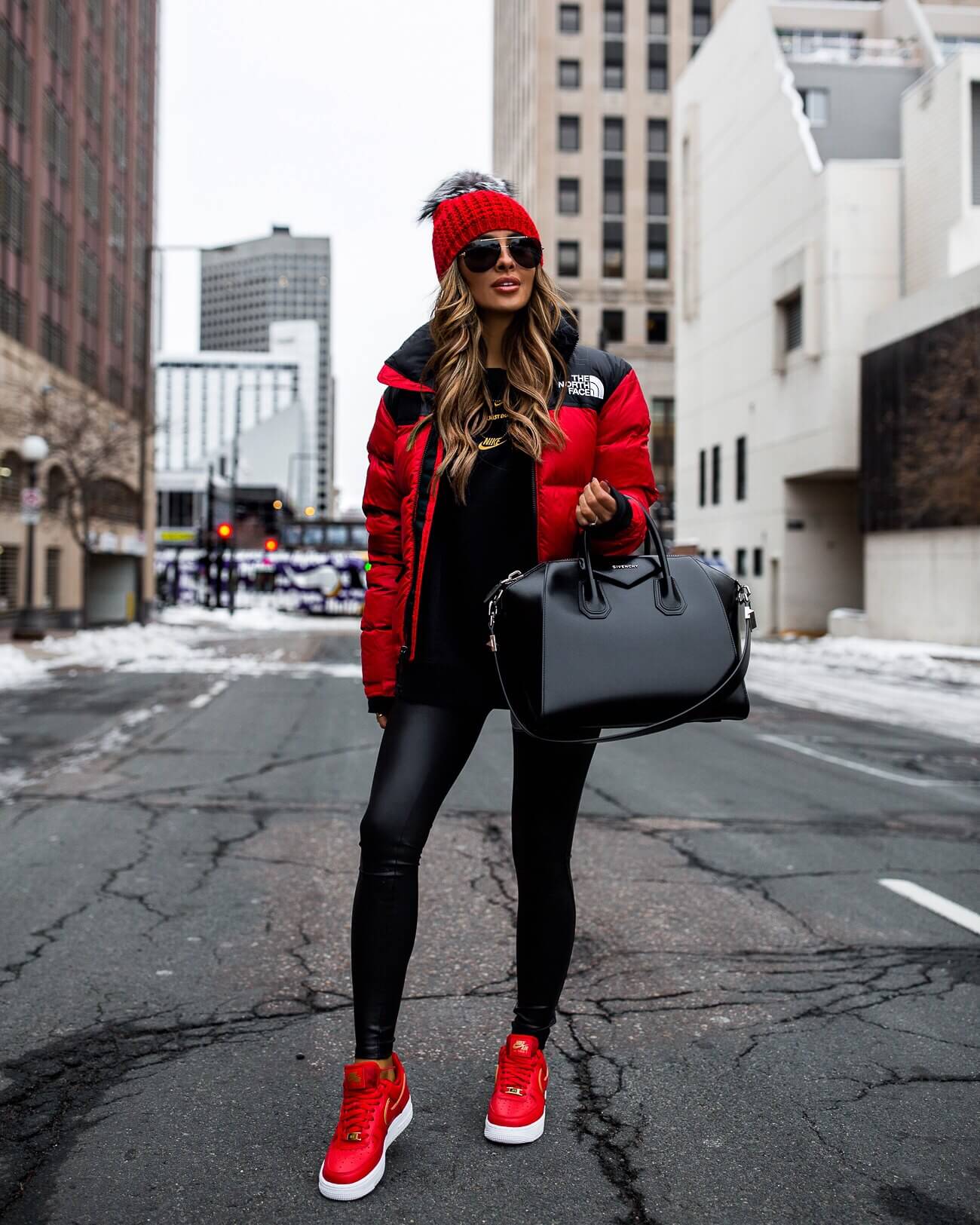fashion blogger mia mia mine wearing a red puffer jacket and red nike sneakers from nordstrom