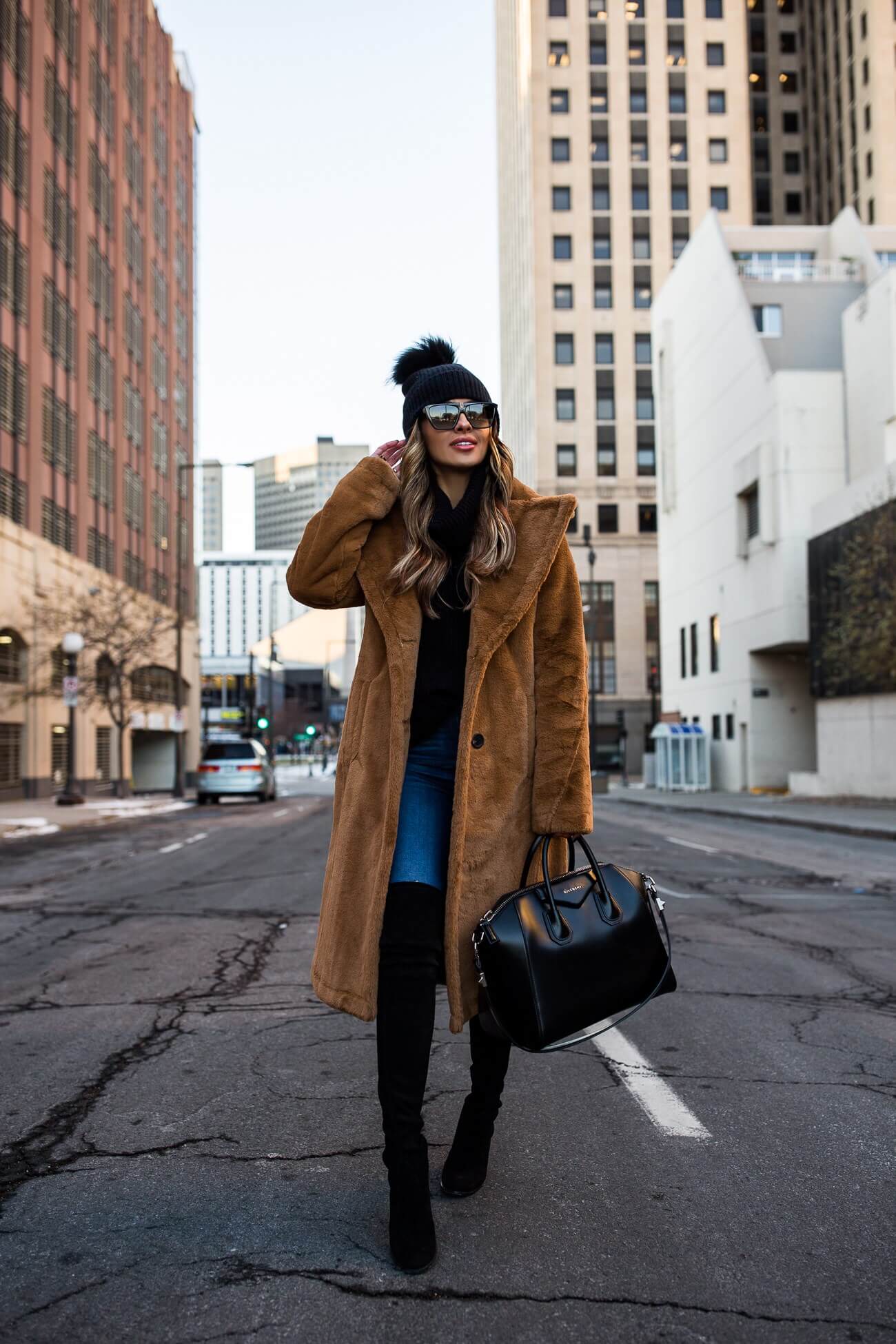 fashion blogger mia mia mine wearing a faux fur coat from saks off 5th