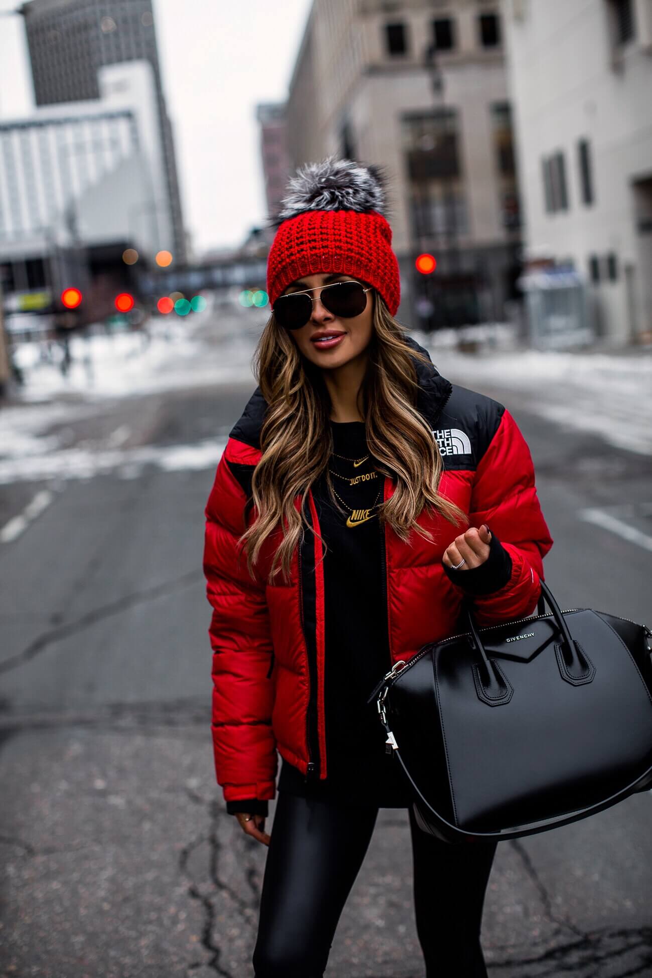 mia mia mine wearing a red north face jacket and a red kyi kyi beanie