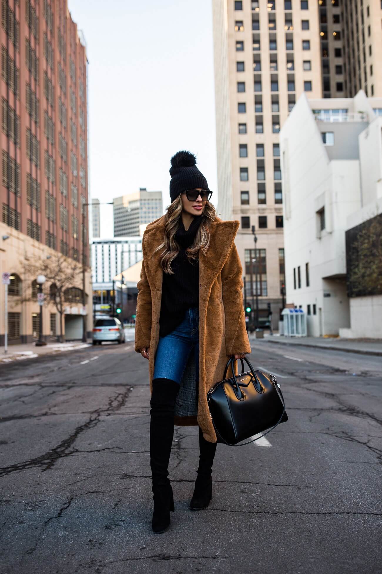 fashion blogger mia mia mine wearing a faux fur coat from saks off 5th with a black pom pom beanie