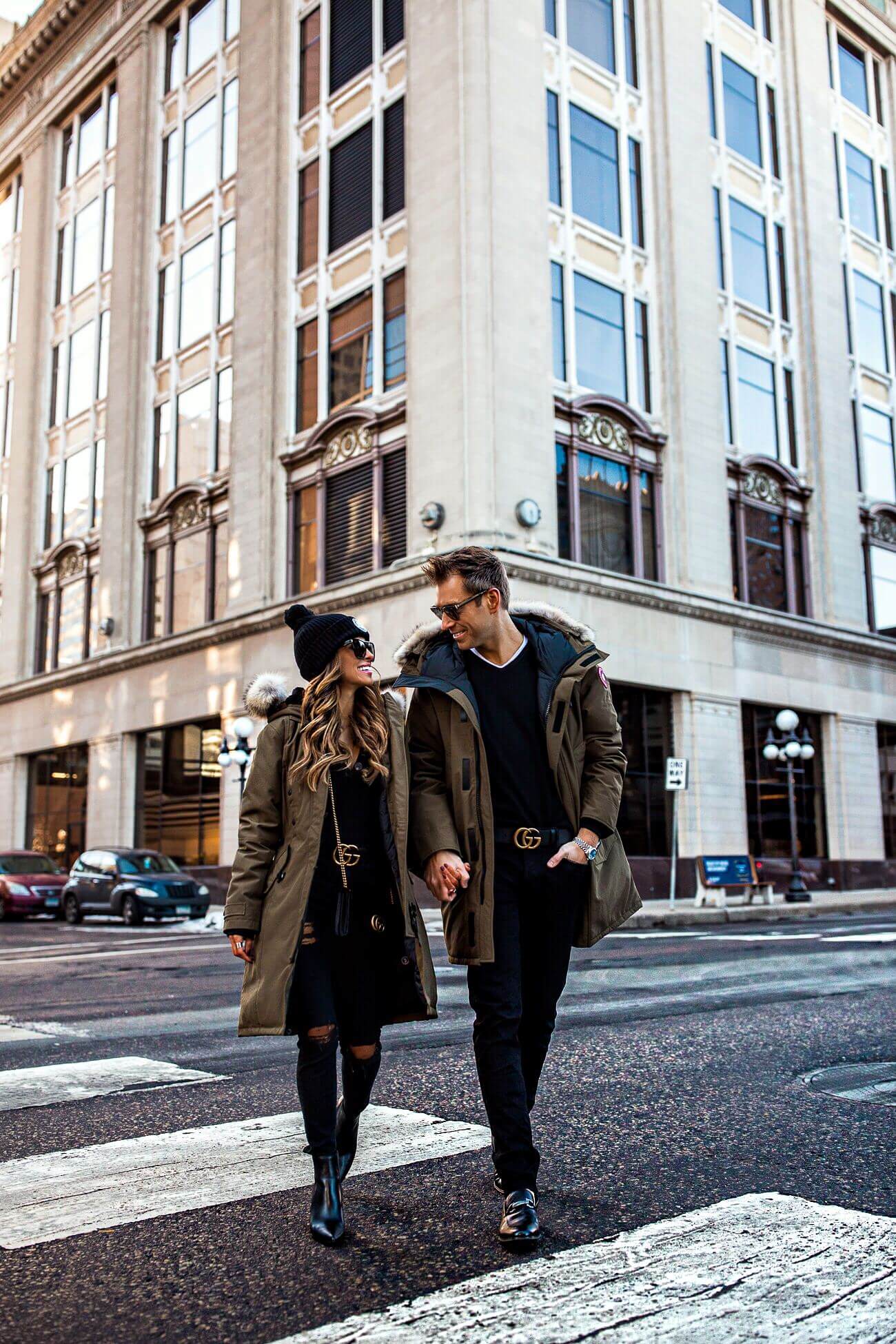 fashion blogger mia mia mine with husband phil thompson wearing a canada goose jacket and gucci belts
