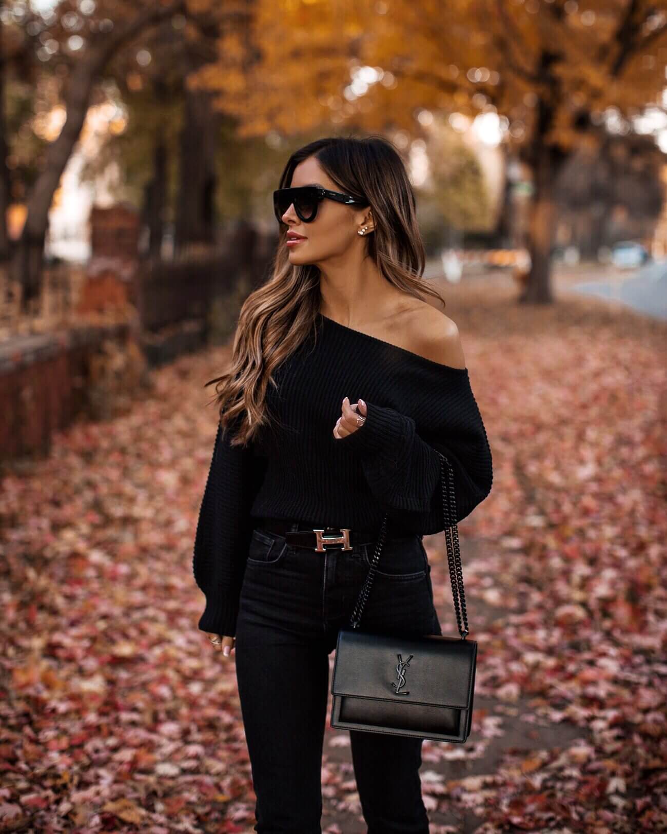 fashion blogger mia mia mine wearing a black off the shoulder sweater from revolve