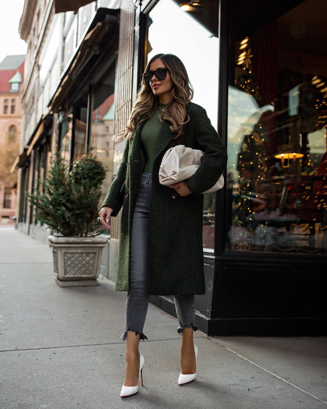 fashion blogger mia mia mine wearing an olive green coat and a bottega veneta bag