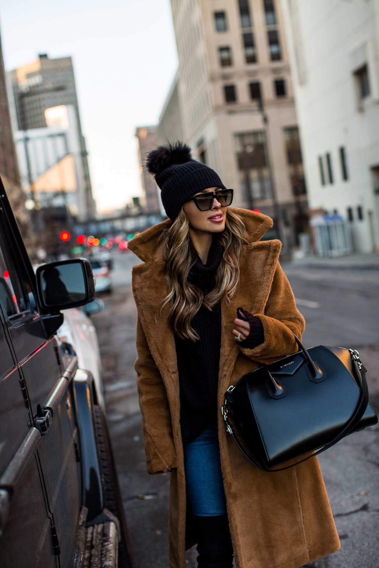 fashion blogger mia mia mine wearing a camel faux fur coat from saks off 5th