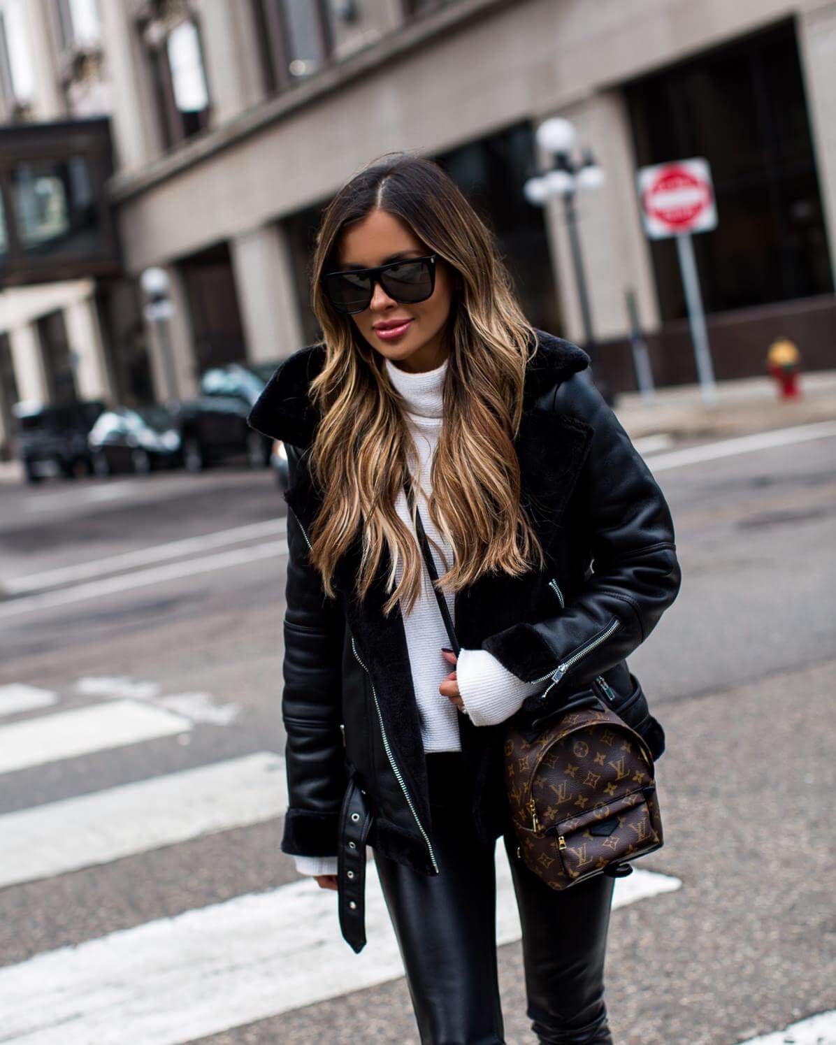 fashion blogger mia mia mine wearing a biker jacket and a louis Vuitton palm springs mini backpack
