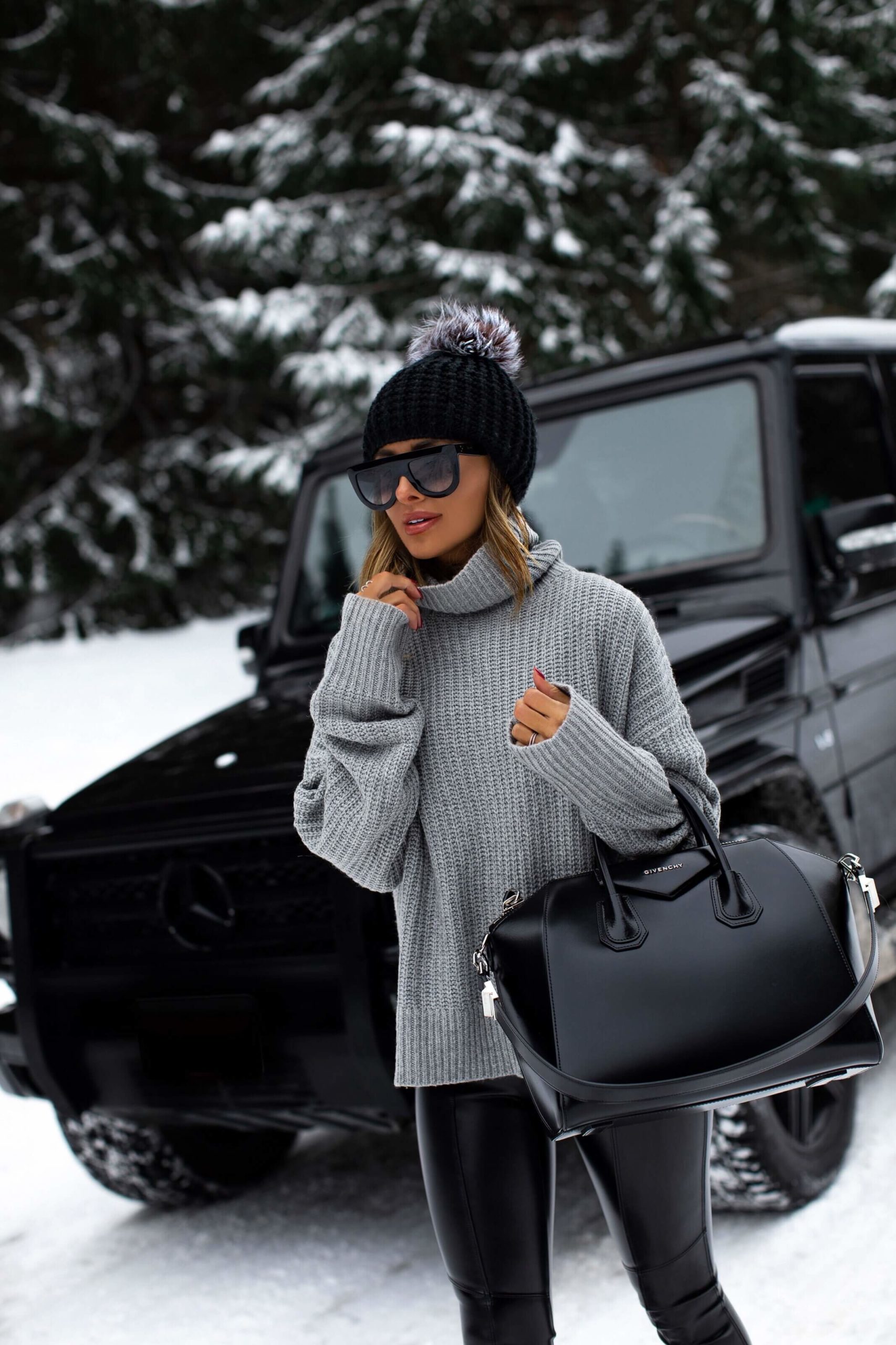 fashion blogger mia mia mine wearing a chunky gray sweater and a givenchy antigona bag