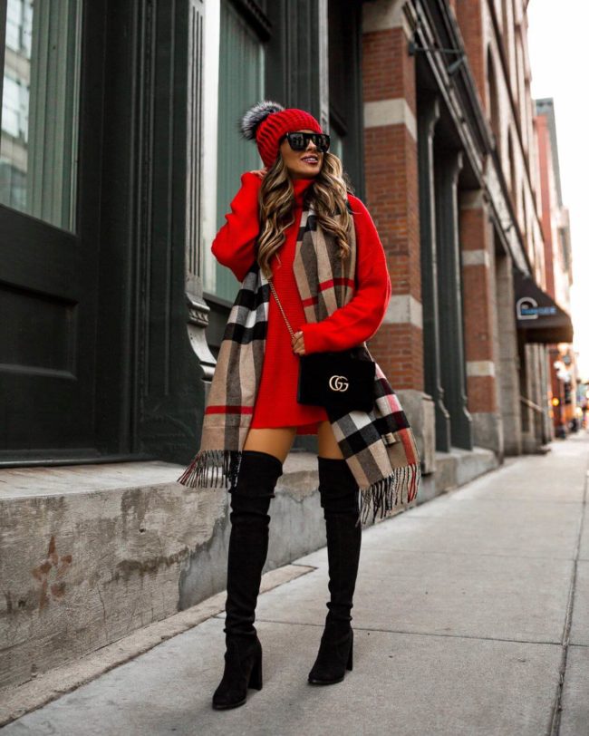 fashion blogger mia mia mine wearing a red sweater dress 