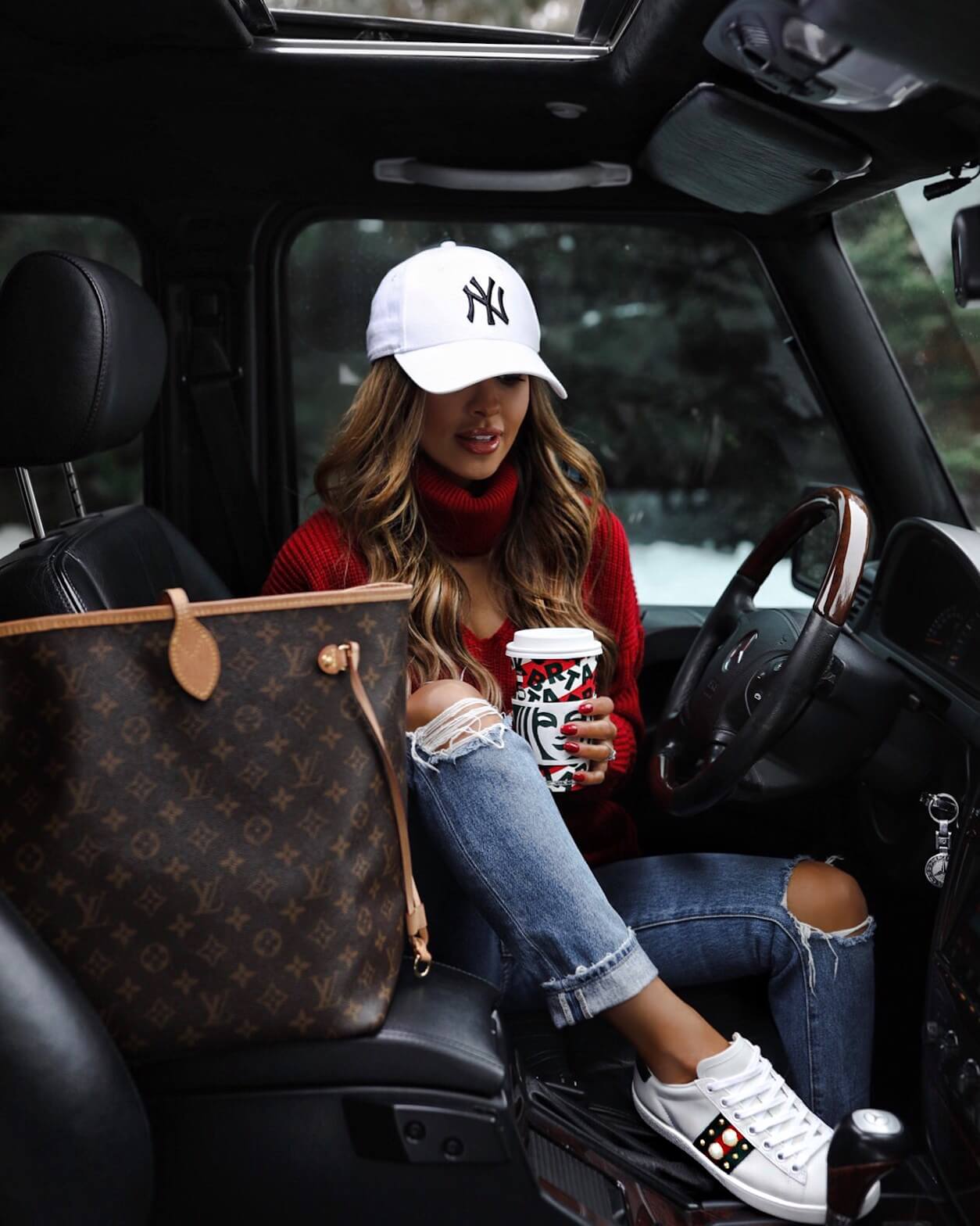 fashion blogger mia mia mine wearing a red sweater from revolve for the holidays with gucci ace sneakers 