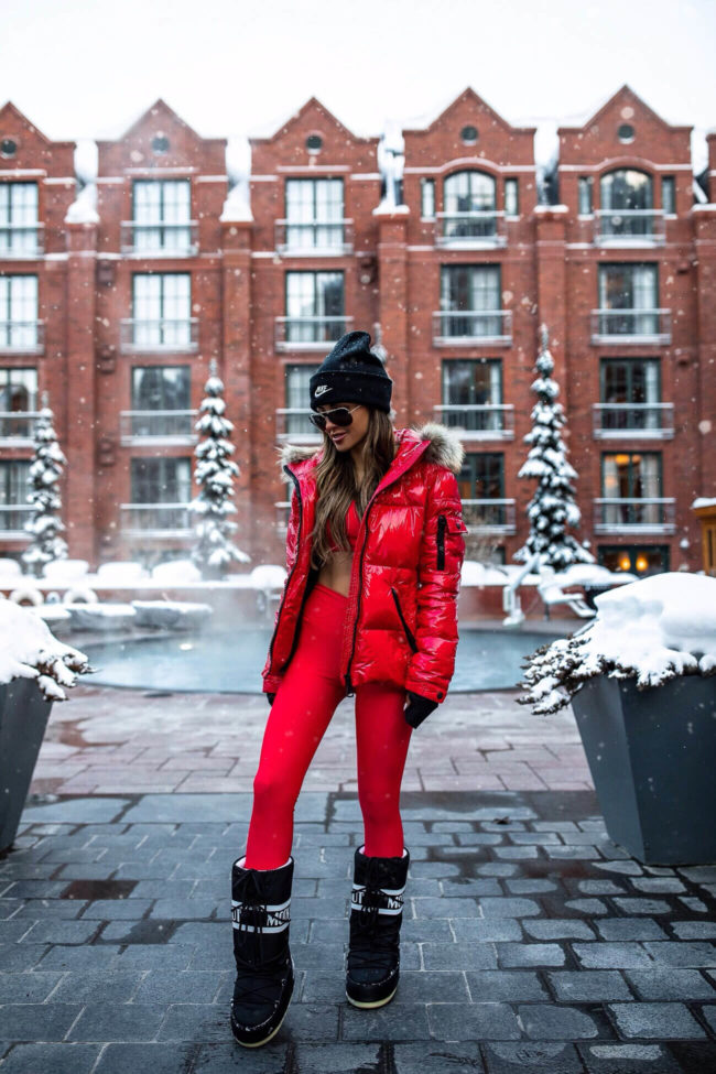 fashion blogger mia mia mine wearing a red workout outfit in aspen