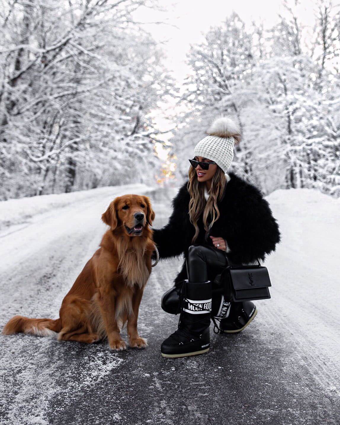 fashion blogger mia mia mine wearing a feather jacket and moon boots in winter