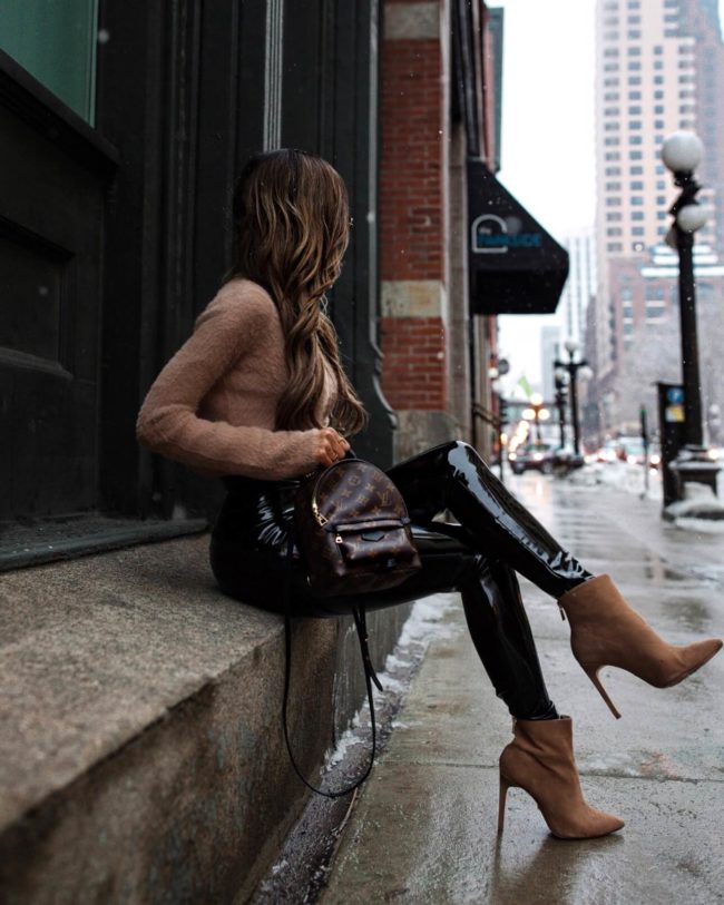 fashion blogger mia mia mine wearing patent leather leggings and a camel fuzzy sweater from revolve
