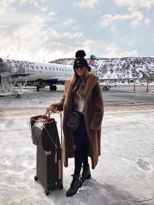 fashion blogger mia mia mine wearing a max mara teddy bear coat at the aspen airport