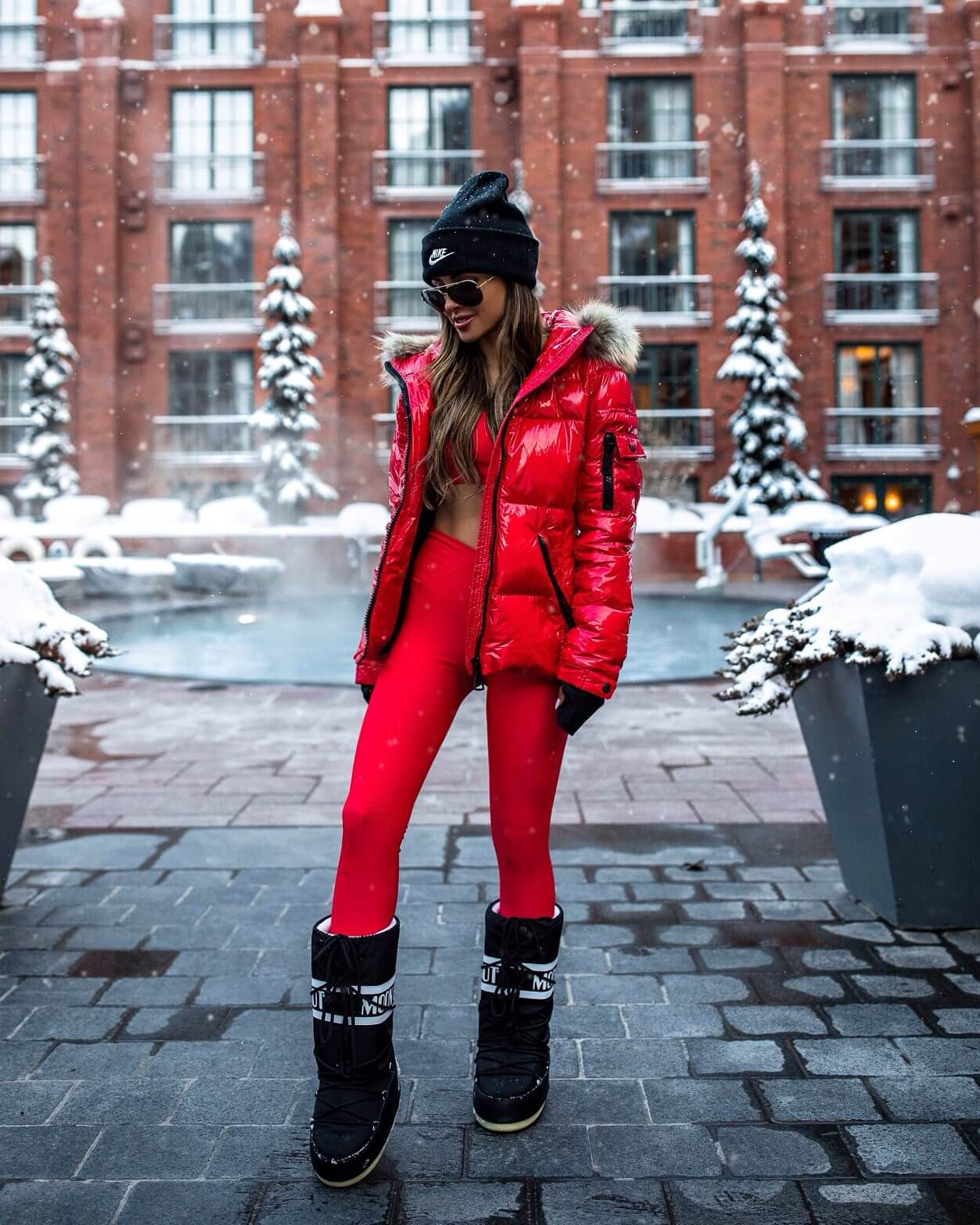 fashion blogger mia mia mine wearing a red workout outfit at the st. regis in aspen