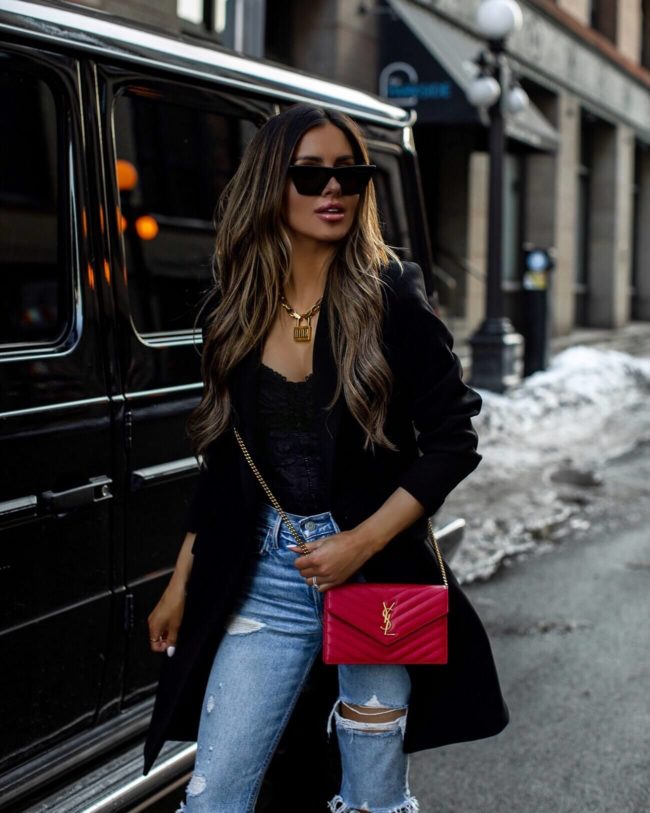 fashion blogger mia mia mine wearing a black blazer and a red saint laurent bag