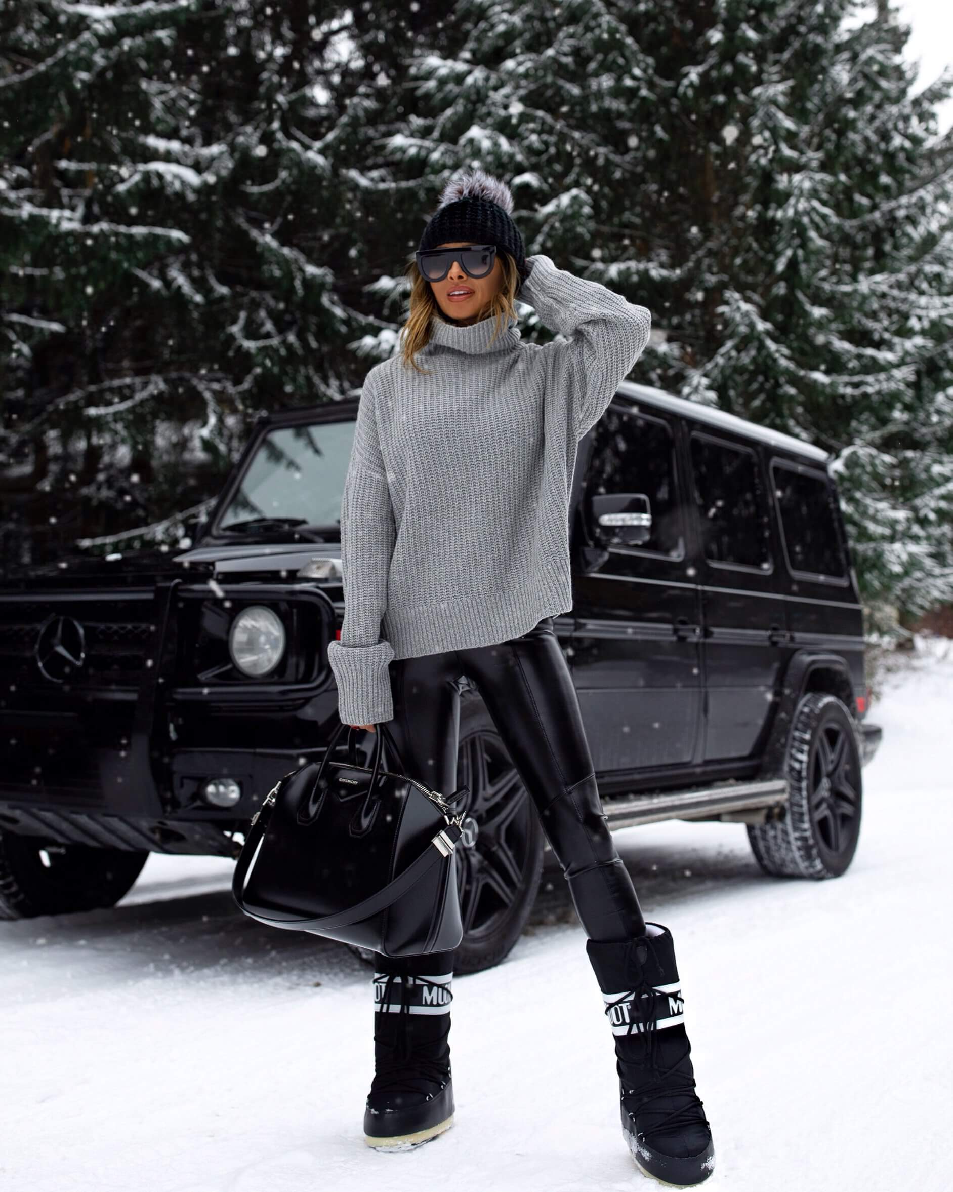 fashion blogger mia mia mine wearing a gray chunky sweater and leather leggings from verishop