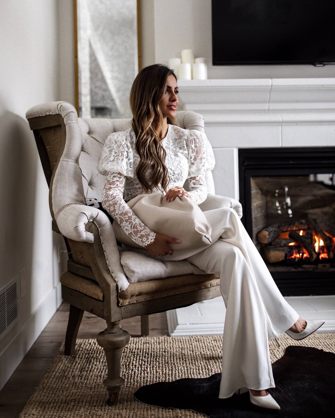 fashion blogger mia mia mine wearing a white lace crop top and white pants from revolve