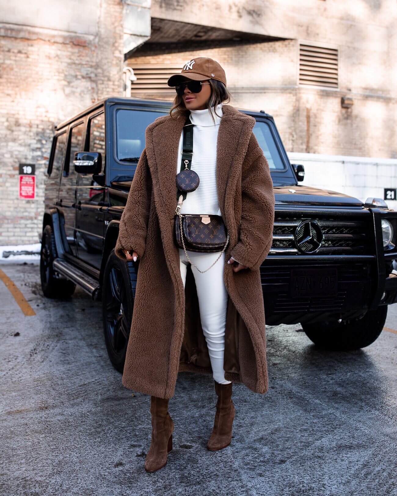 fashion blogger mia mia mine wearing a max mara coat with a camel new york yankees cap