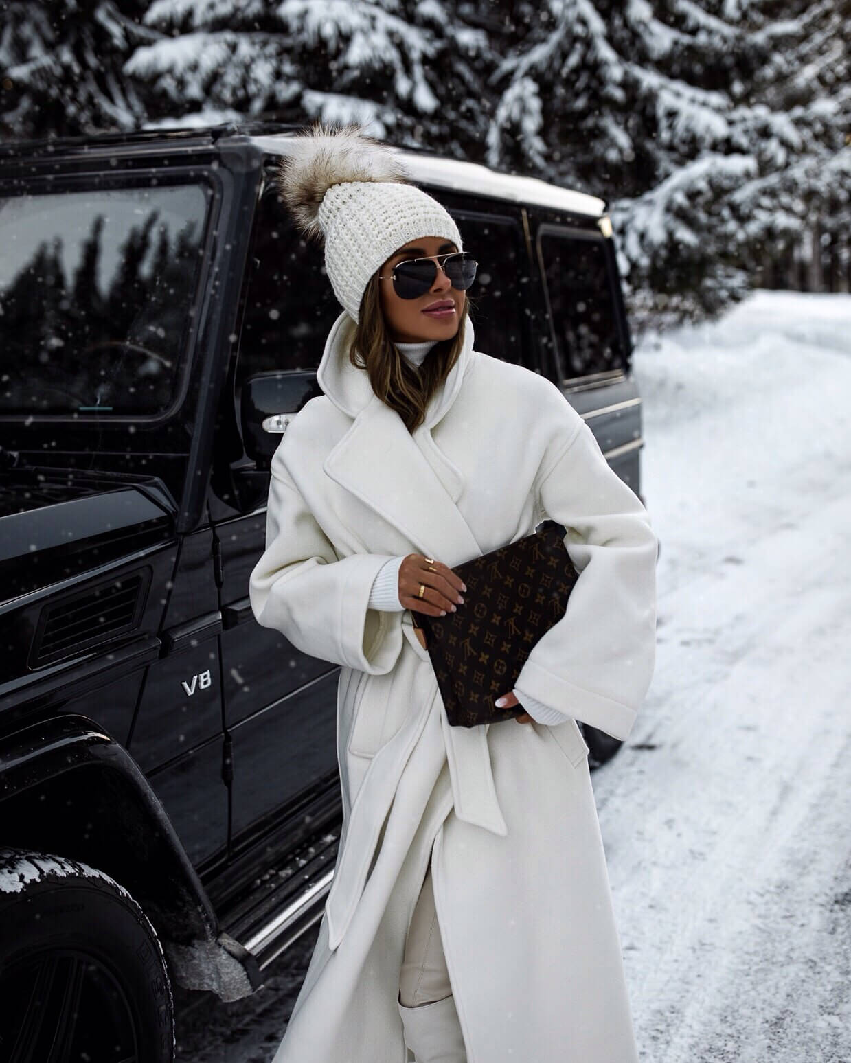 fashion blogger mia mia mine wearing a white coat and a white beanie for winter