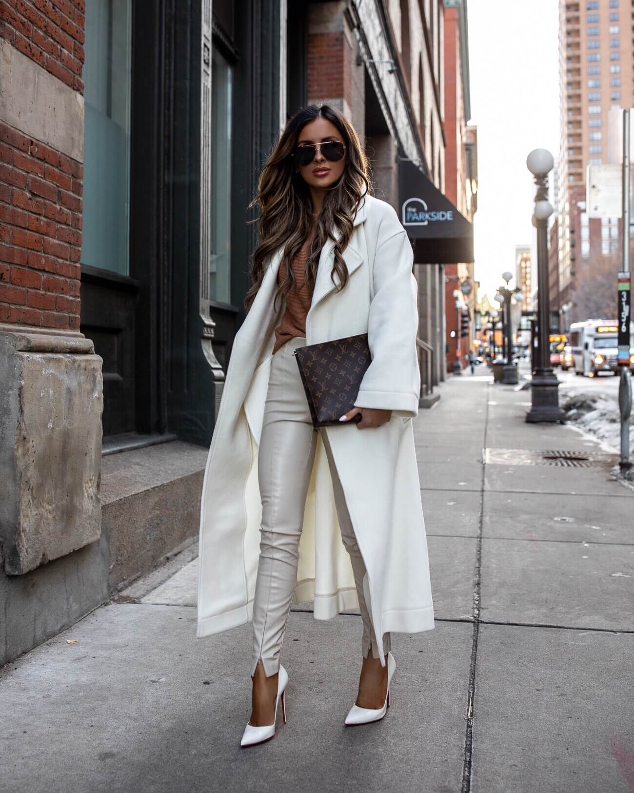 fashion blogger mia mia mine wearing a white coat from mango and a louis vuitton toiletry pouch 26