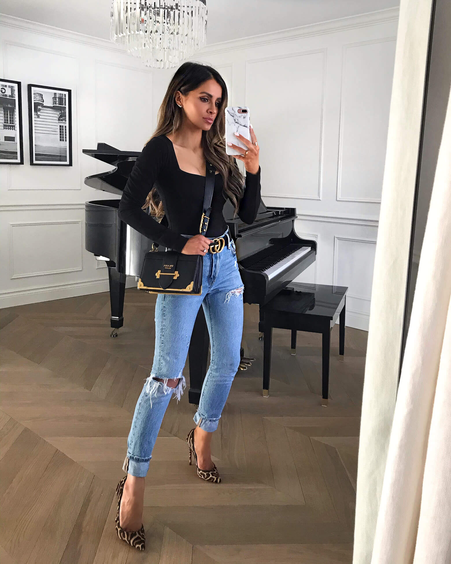 fashion blogger mia mia mine wearing a prada cahier bag and levi's denim